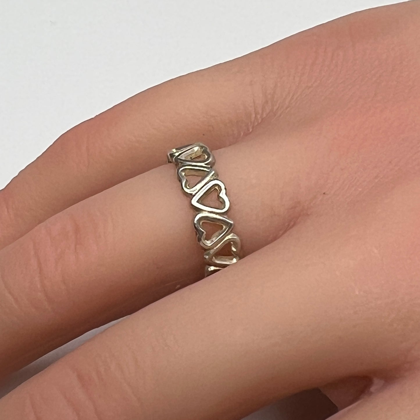 Close-up of silver open-heart design ring with 5mm band
