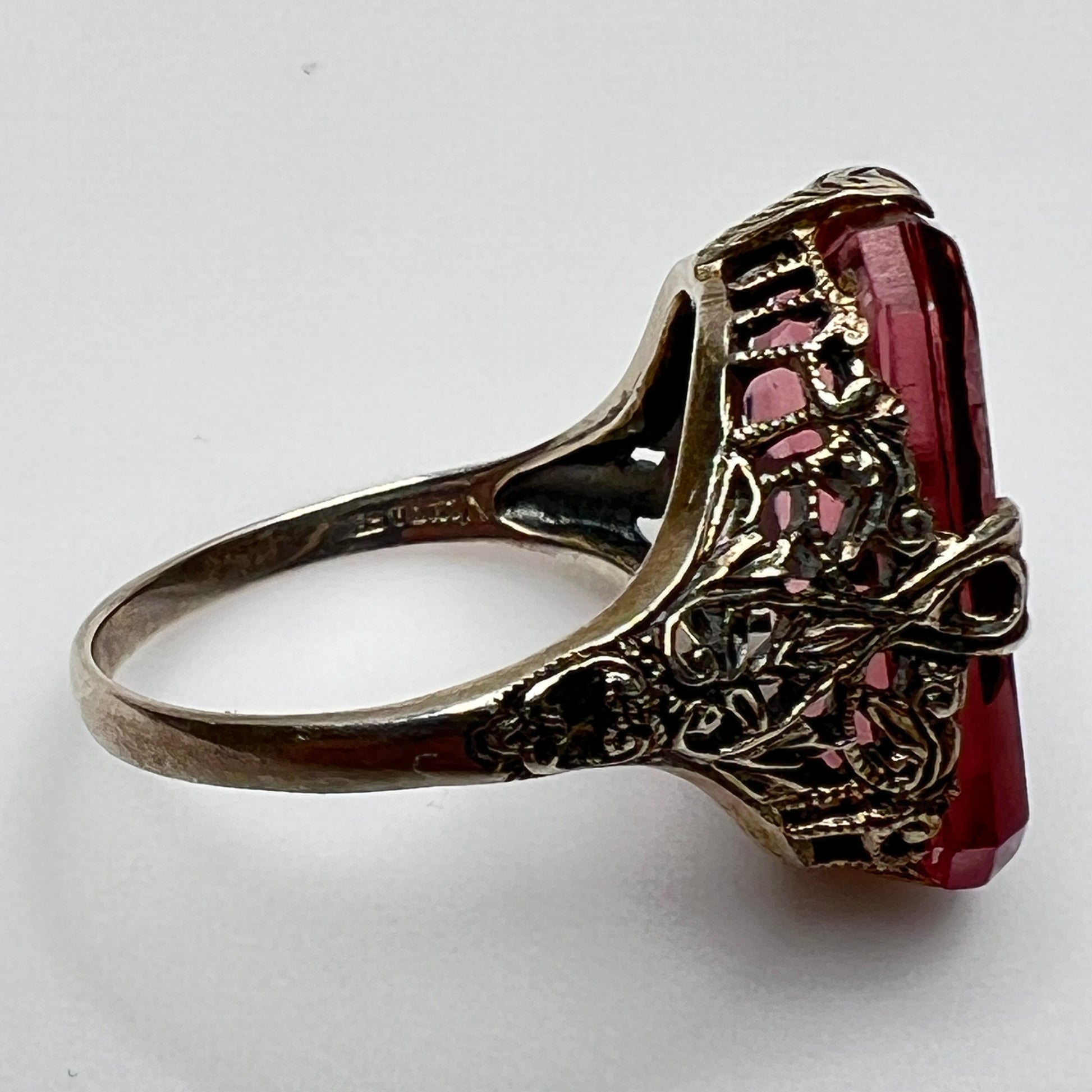 Side view of antique filigree ring with amethyst crystal and sterling setting