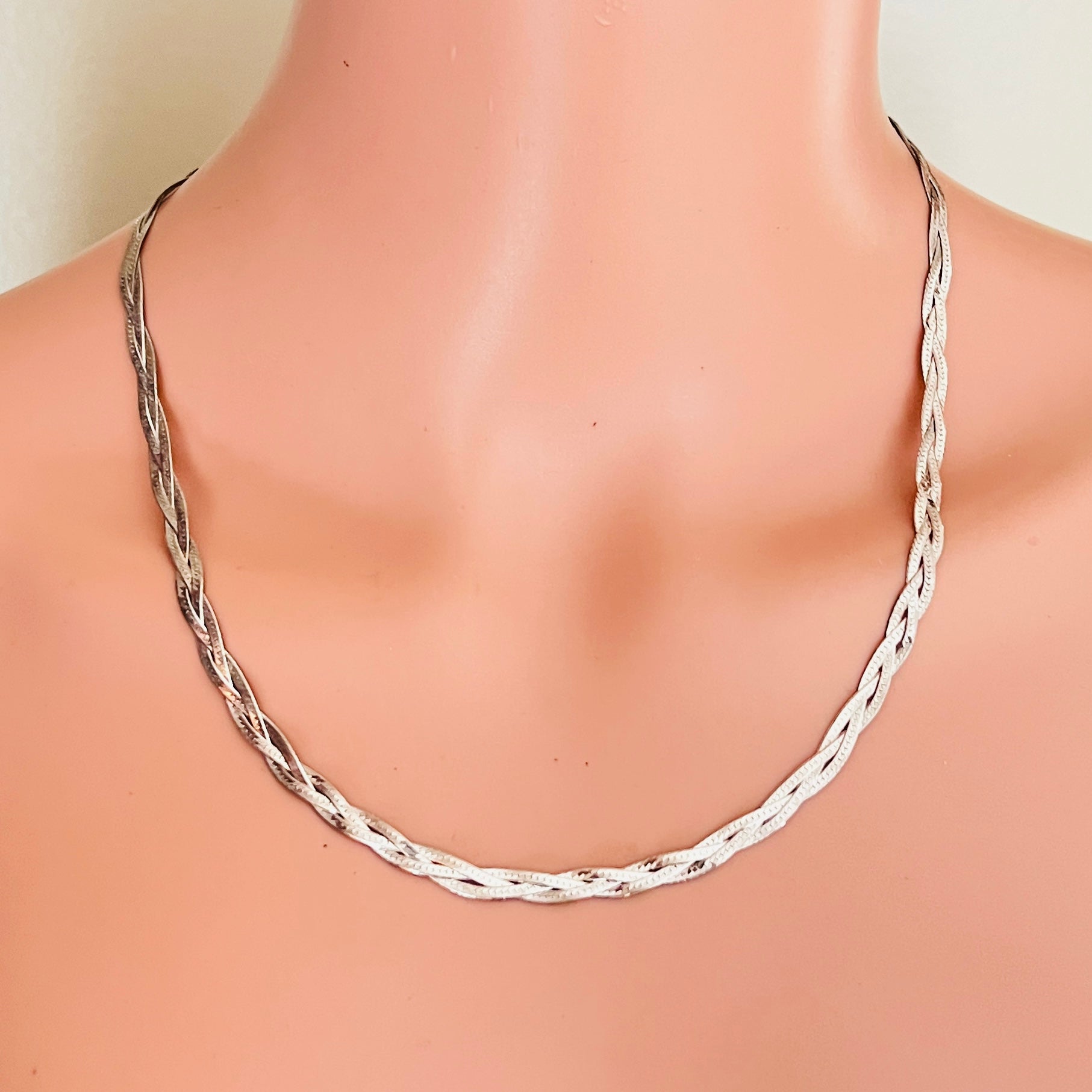 Sterling silver braided chain necklace worn on mannequin