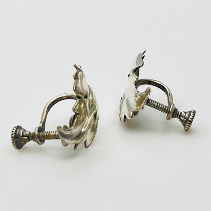 Side angle showing screw-back earring hardware and curved leaf shape