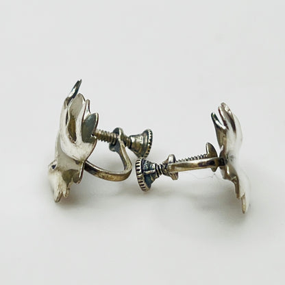 Side angle showing screw-back earring hardware and curved leaf shape