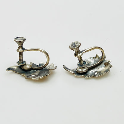 Side angle showing screw-back earring hardware and curved leaf shape