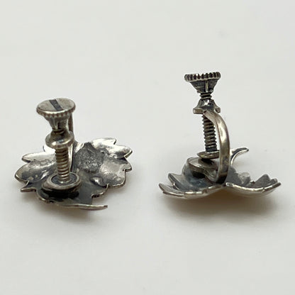 Side angle showing screw-back earring hardware and curved leaf shape