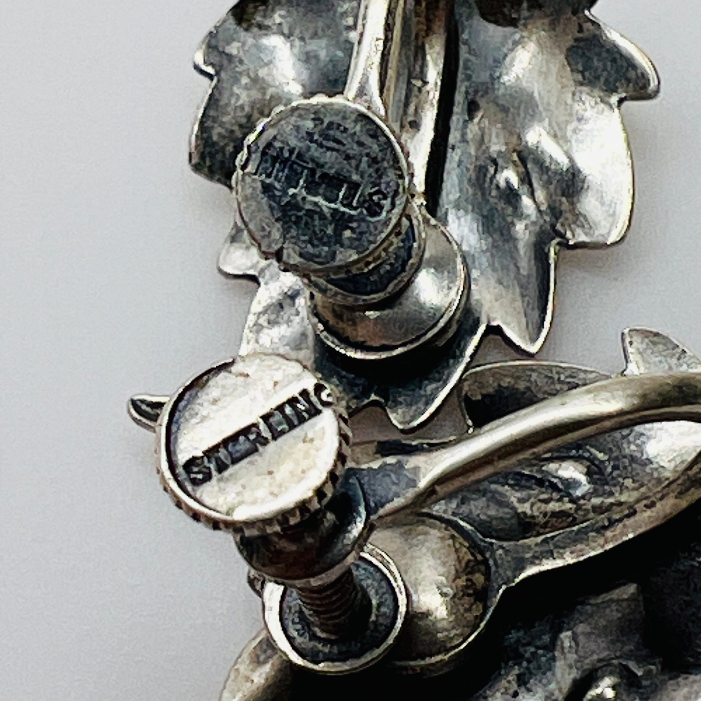 Close-up of sterling stamp on back of earring screw