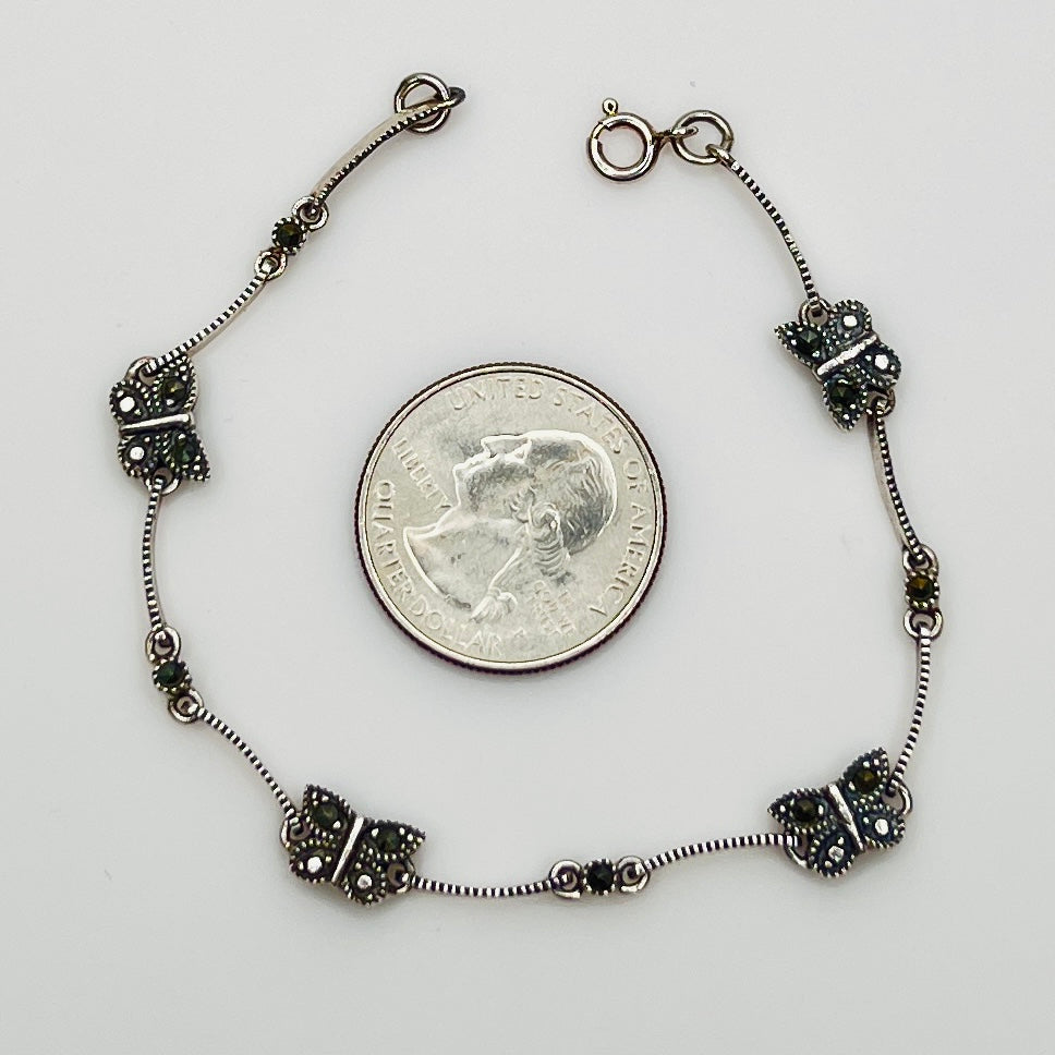 Overhead view of butterfly bracelet laid flat showing clasp and detail