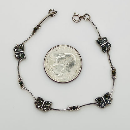 Overhead view of butterfly bracelet laid flat showing clasp and detail