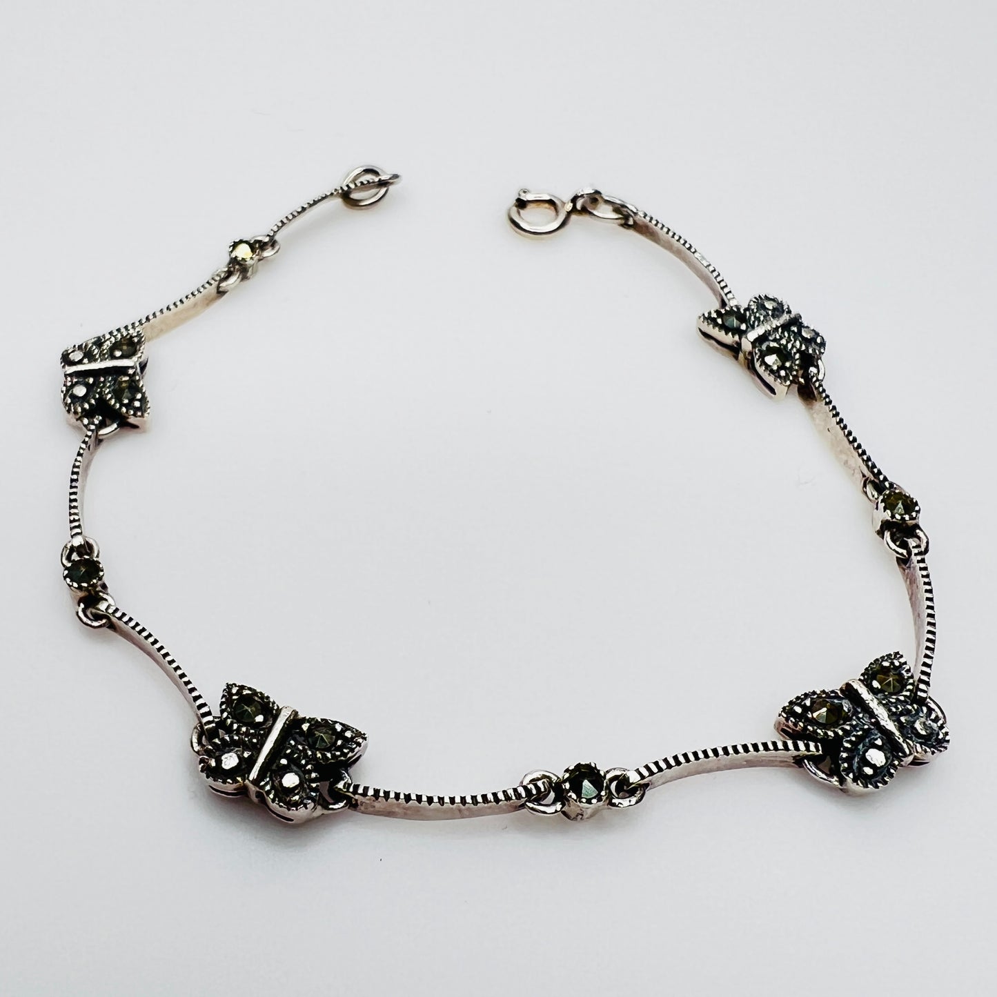 Overhead view of butterfly bracelet laid flat showing clasp and detail