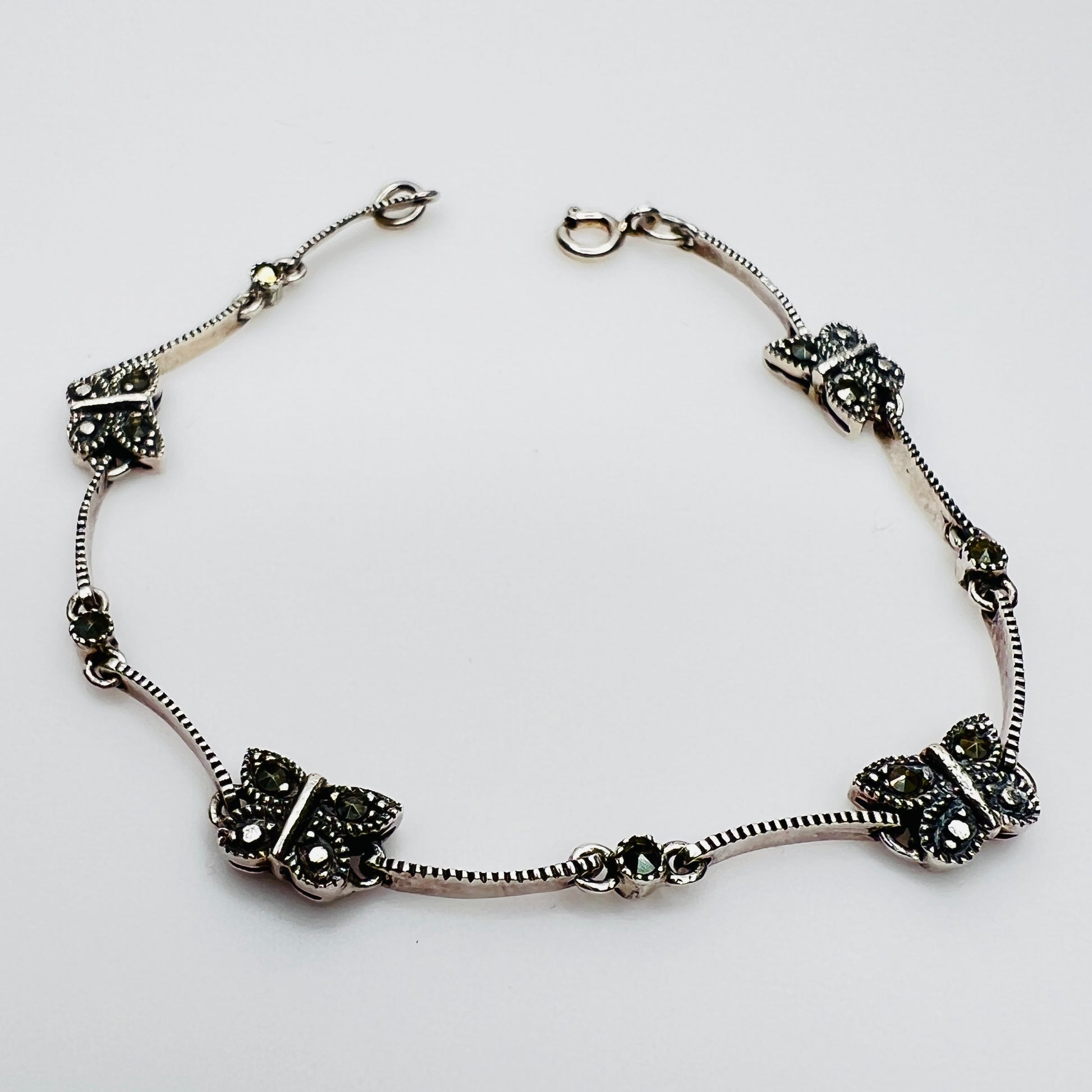 Overhead view of butterfly bracelet laid flat showing clasp and detail