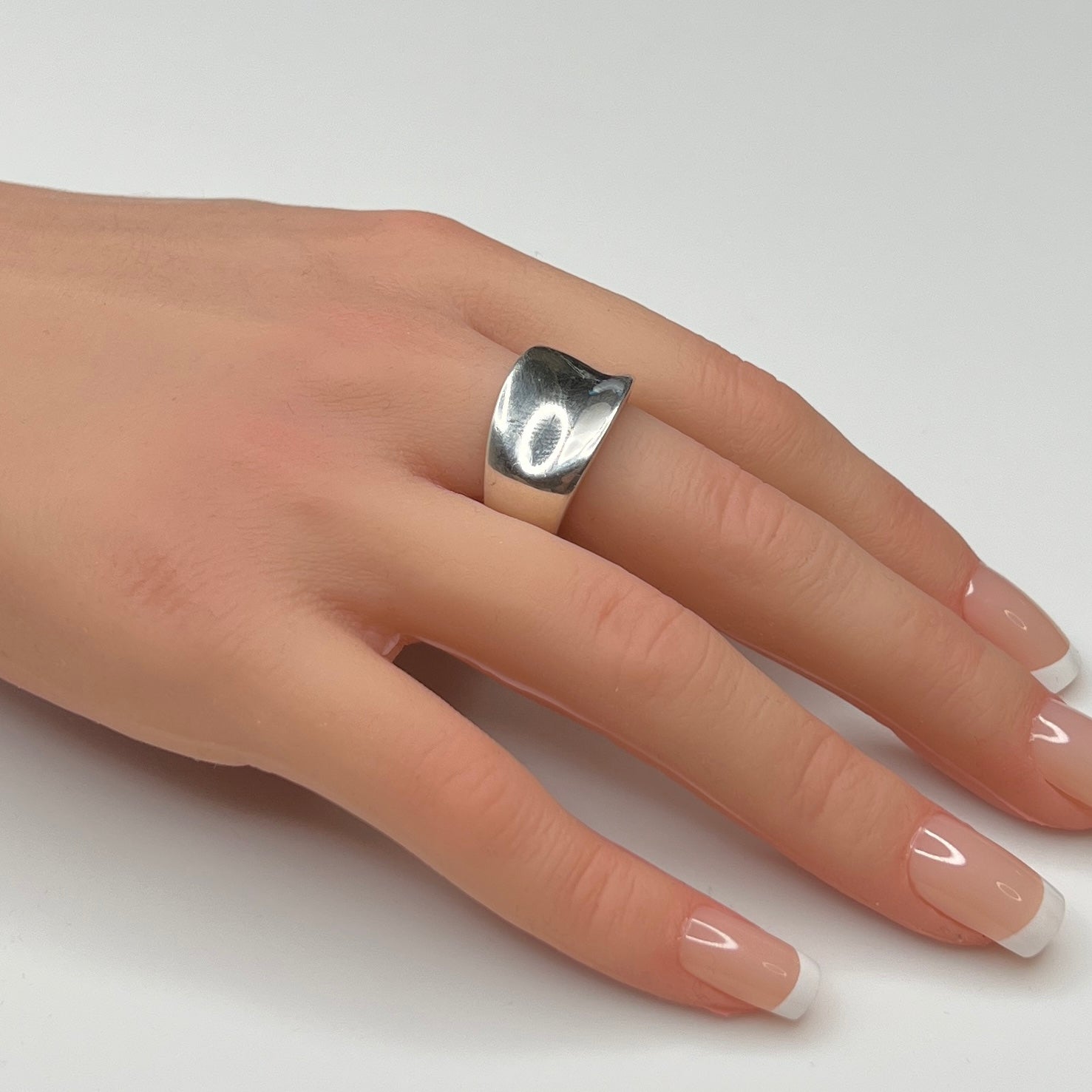 Sterling silver modernist band ring on hand with tapered shape