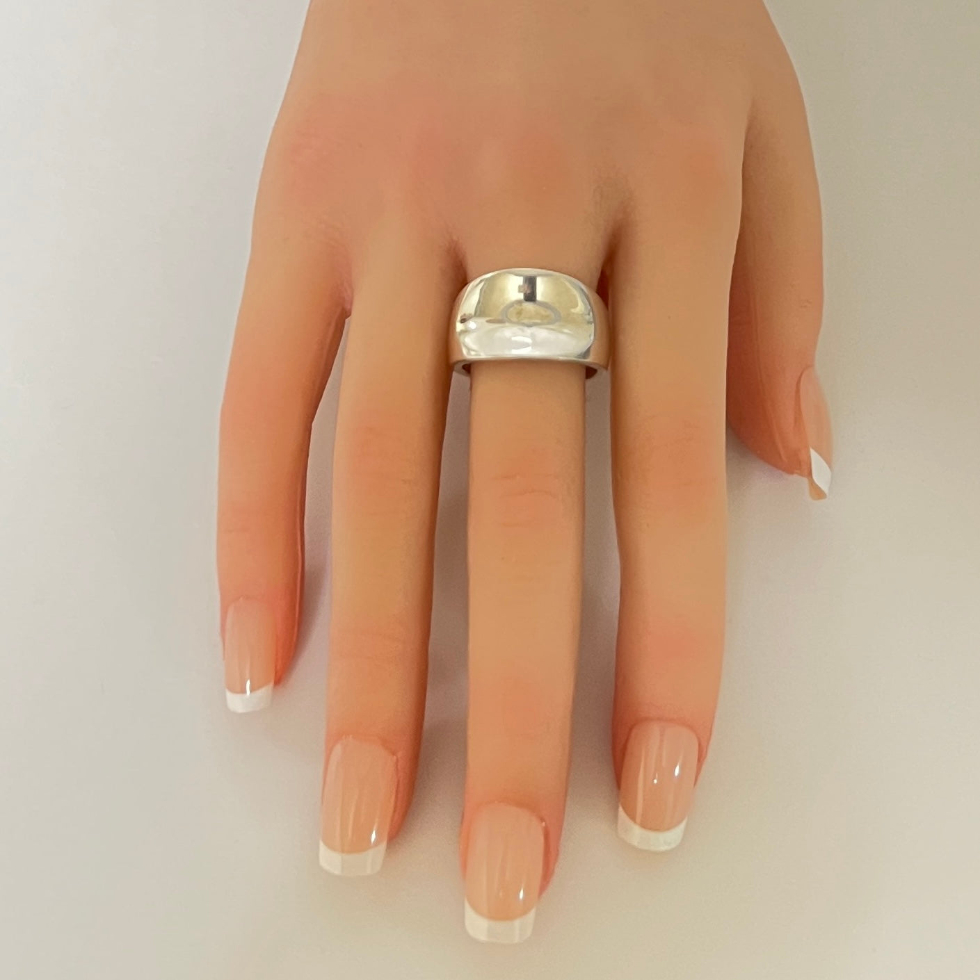 Sterling silver modernist band ring on hand with tapered shape