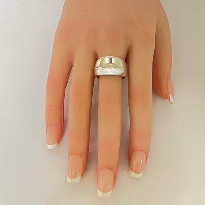 Sterling silver modernist band ring on hand with tapered shape