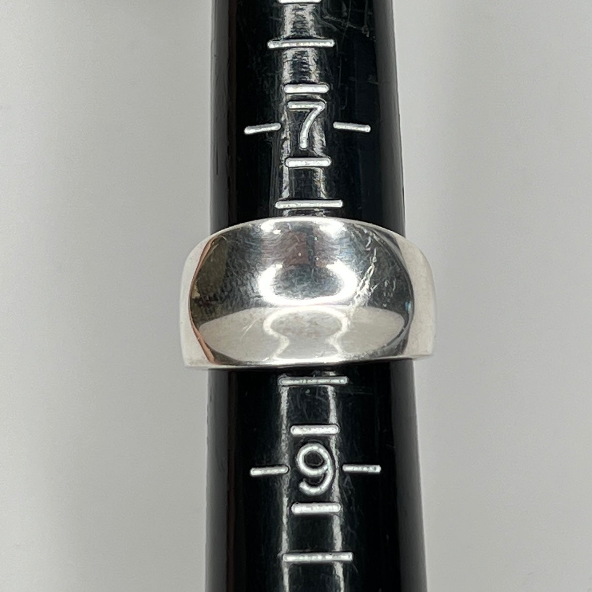 Vintage silver sculptural ring with smooth, polished finish on ring sizer