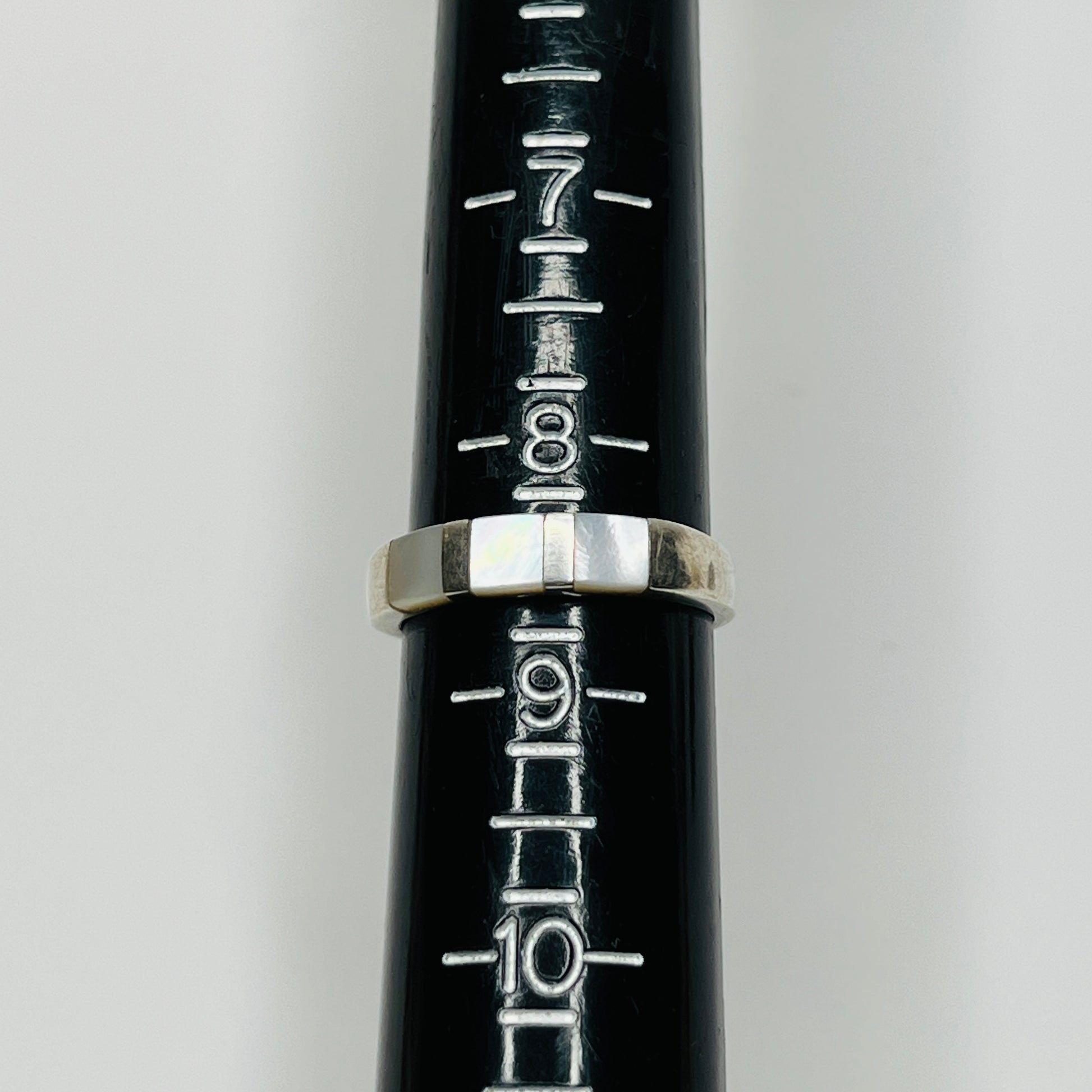 Close-up of iridescent inlay and 925 stamp on inner band
