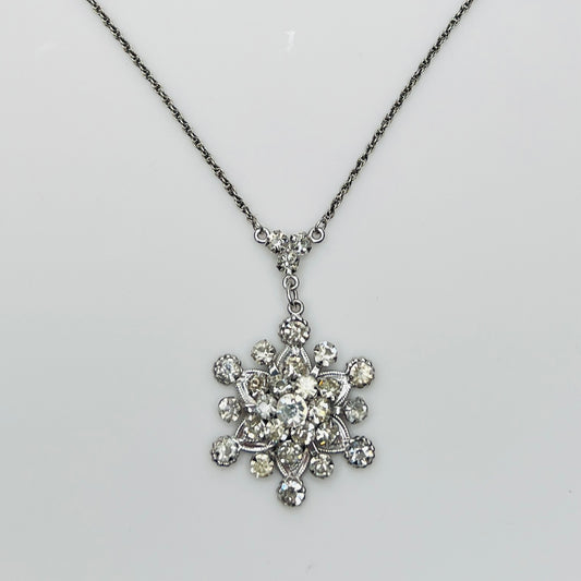 Close-up of clear rhinestone floral pendant in sterling silver setting