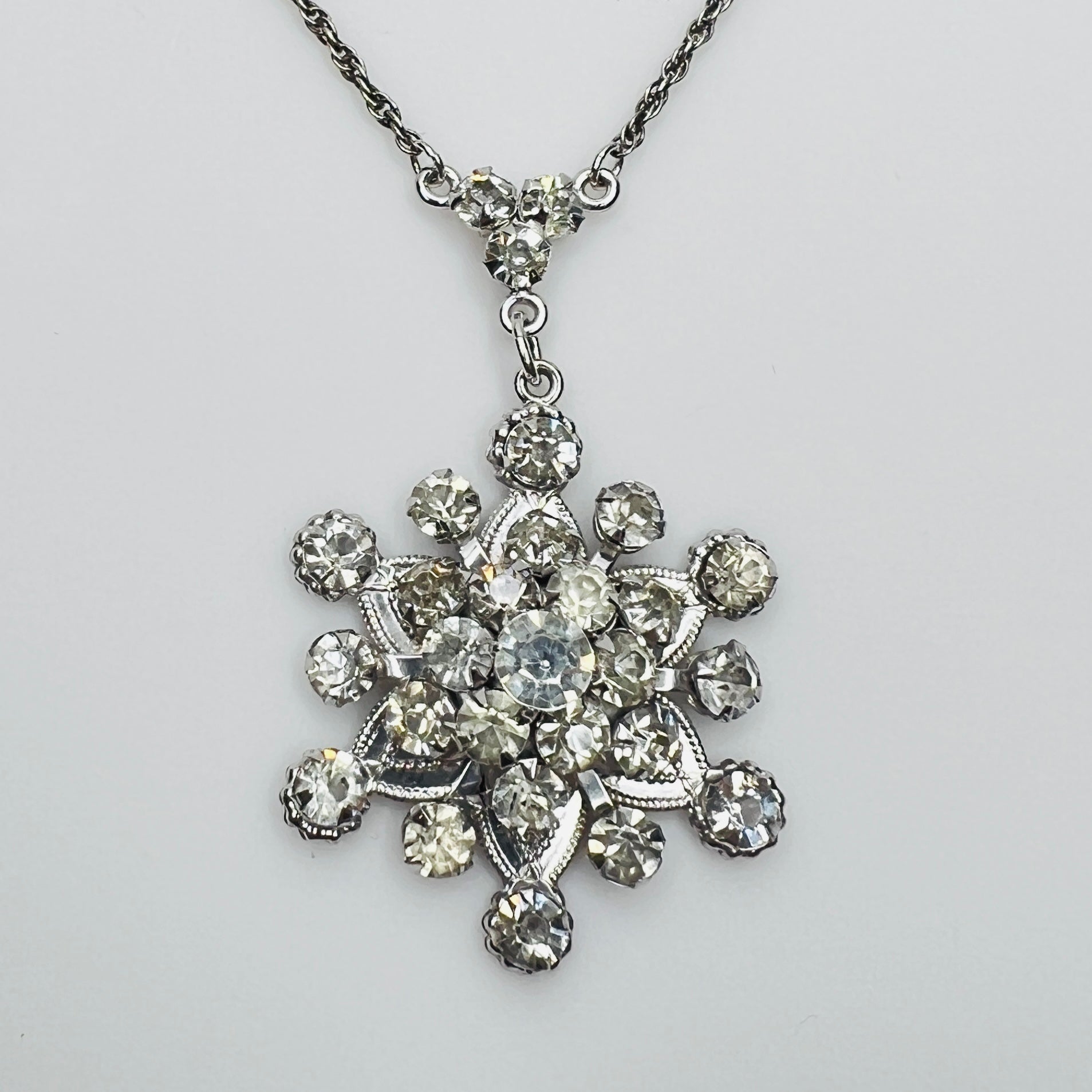 Close-up of clear rhinestone floral pendant in sterling silver setting