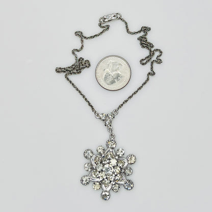 Close-up of clear rhinestone floral pendant in sterling silver setting