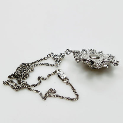 Close-up of clear rhinestone floral pendant in sterling silver setting