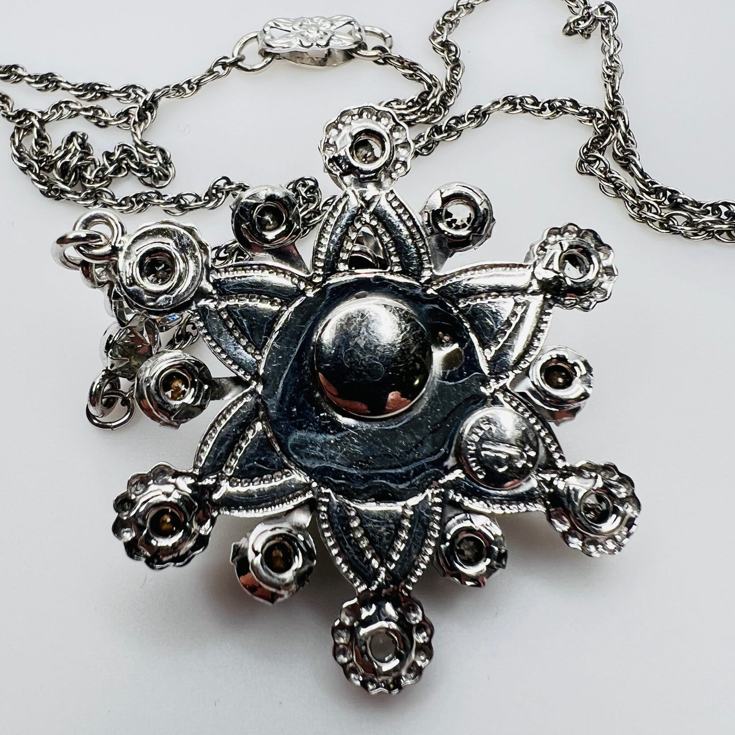 Back of pendant showing Palm Royale maker’s mark and Sterling stamp