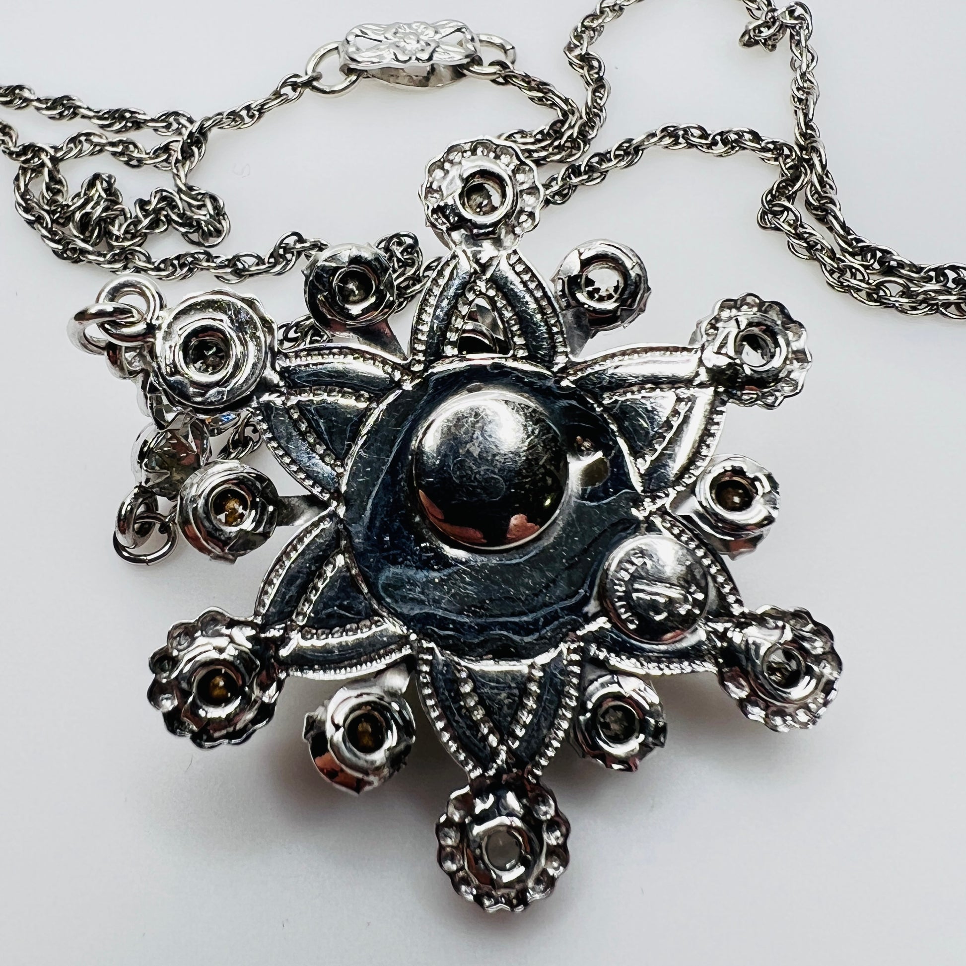 Back of pendant showing Palm Royale maker’s mark and Sterling stamp