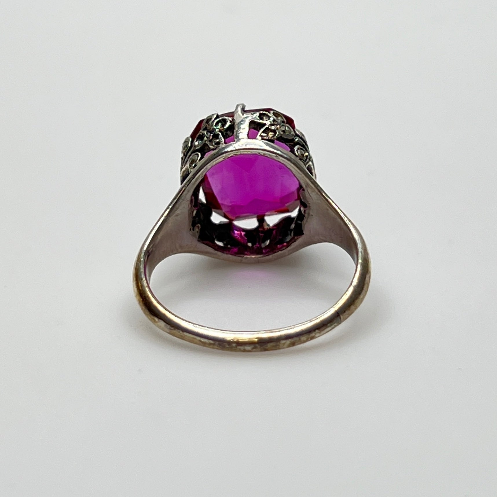 Victorian-style solitaire ring with ornate silver filigree setting