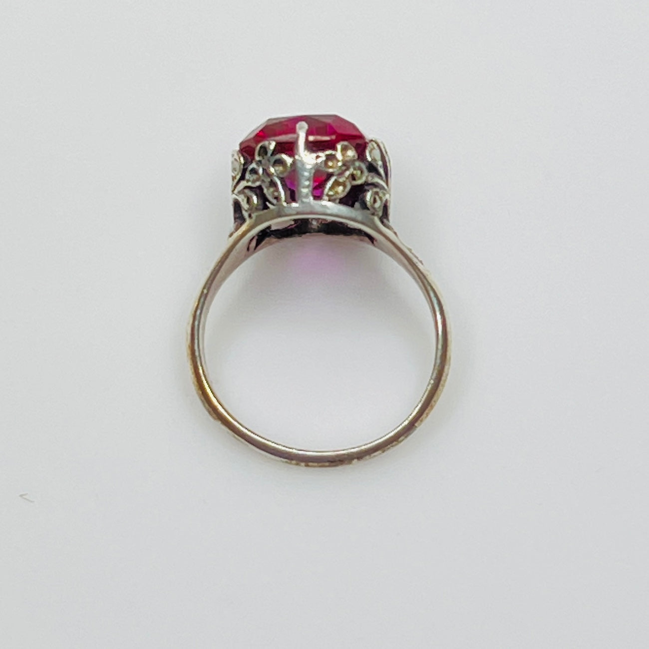 Close-up of pink crystal in sterling ring with antique detailing