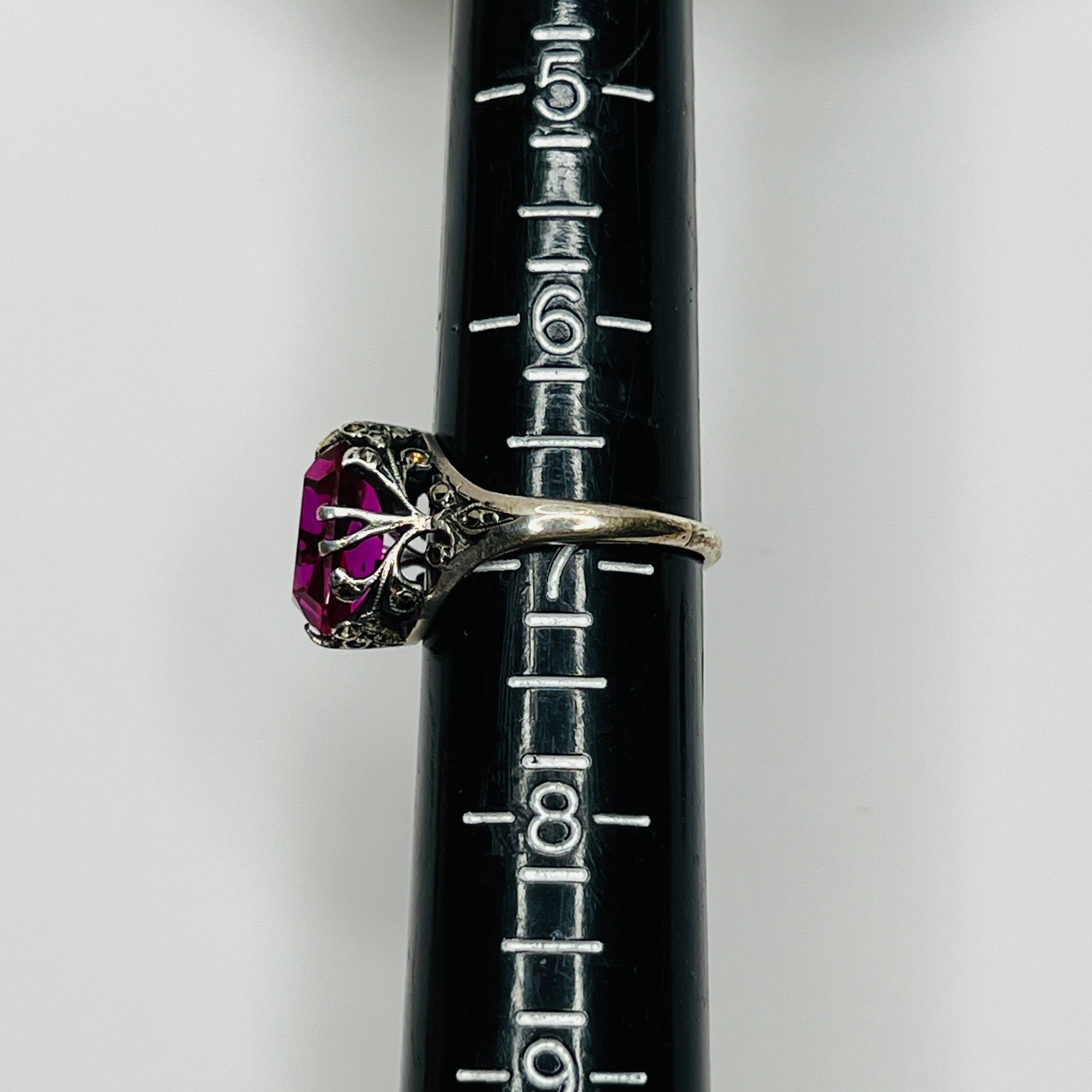 Close-up of pink crystal in sterling ring with antique detailing