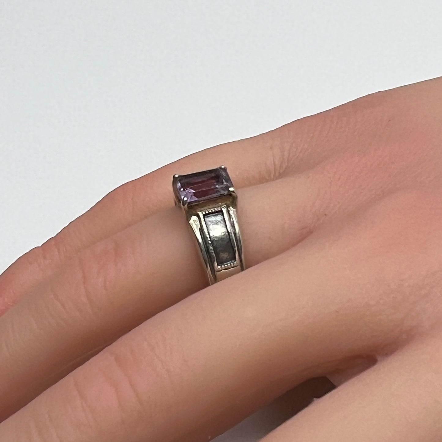 Sterling silver ring with rectangular lavender spinel worn on hand