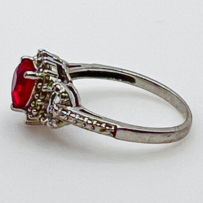 Sterling silver ring with ruby heart center and diamond halo