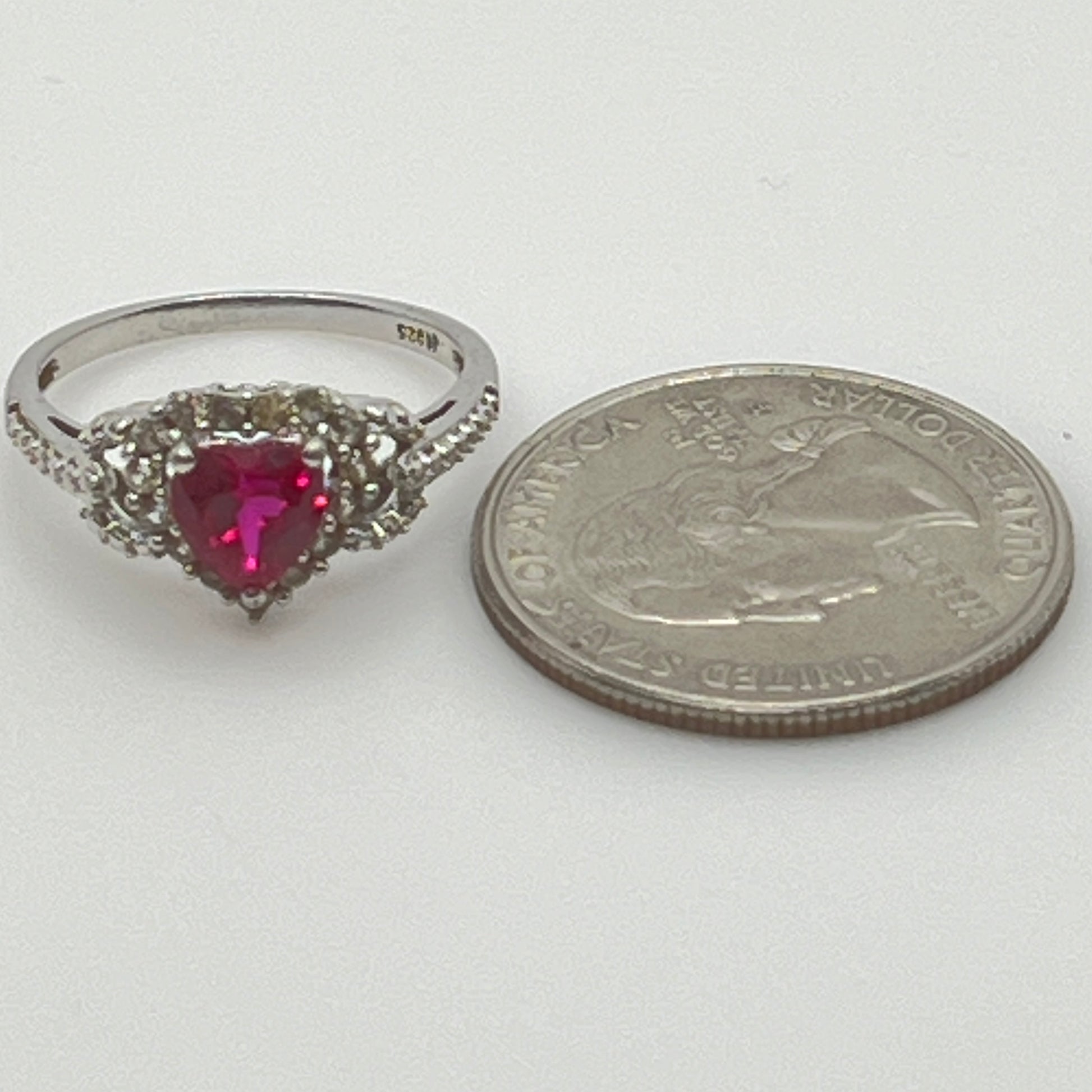 Sterling silver ring with ruby heart center and diamond halo
