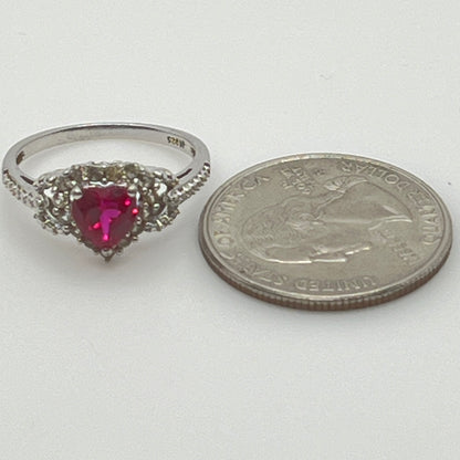 Sterling silver ring with ruby heart center and diamond halo