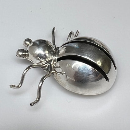 Side view of Taxco silver spider brooch showing dimensional body and leg detail
