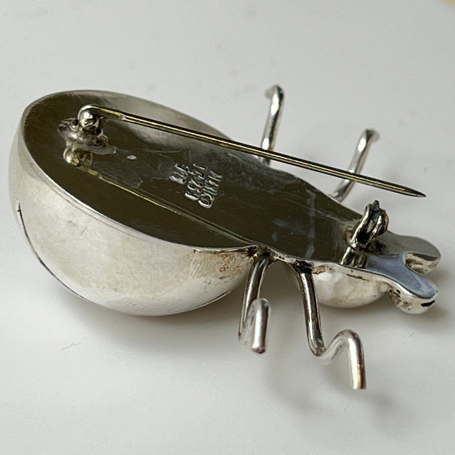 Side view of Taxco silver spider brooch showing dimensional body and leg detail
