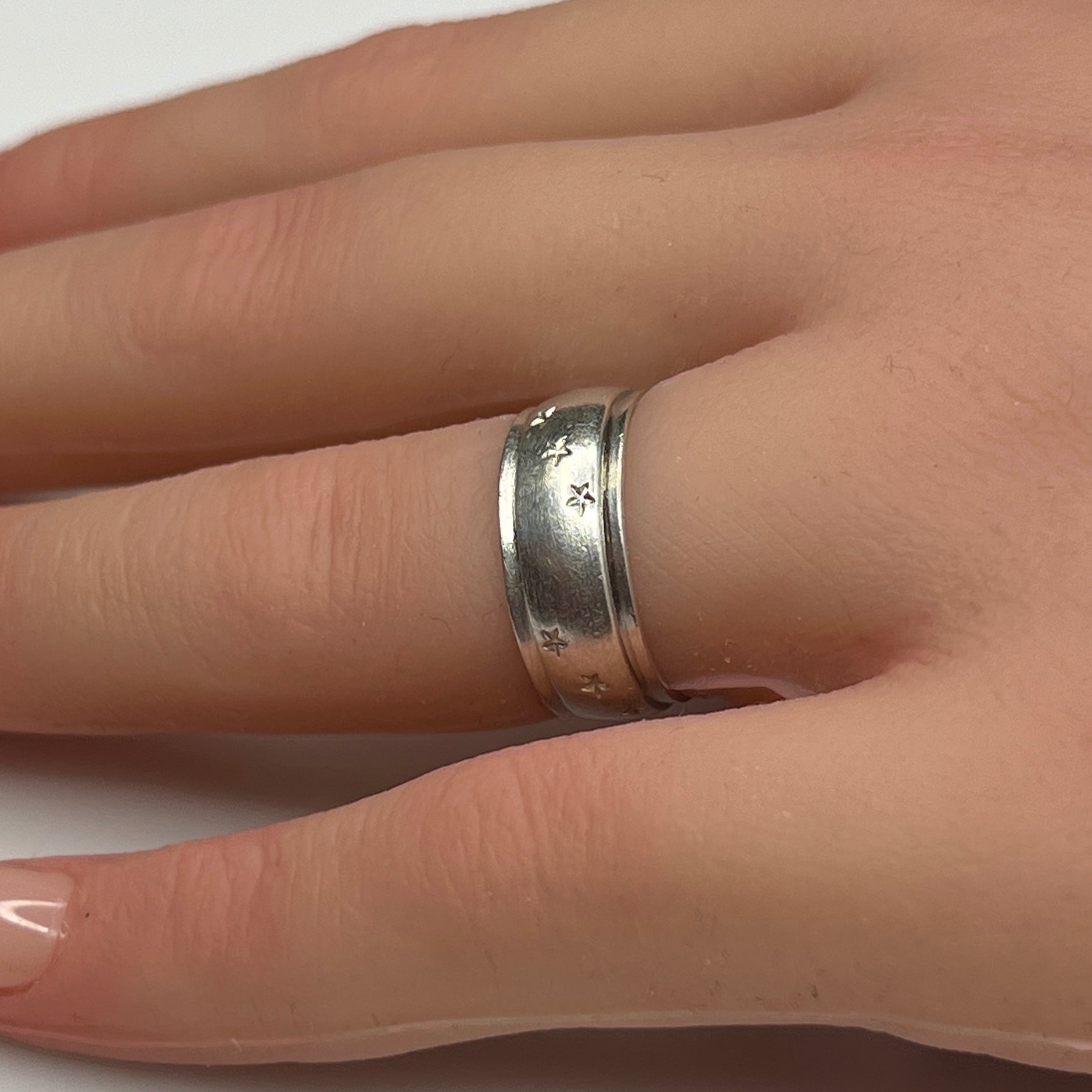Vintage silver star band ring worn on hand