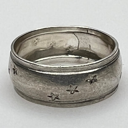 Close-up of engraved sterling ring with star pattern
