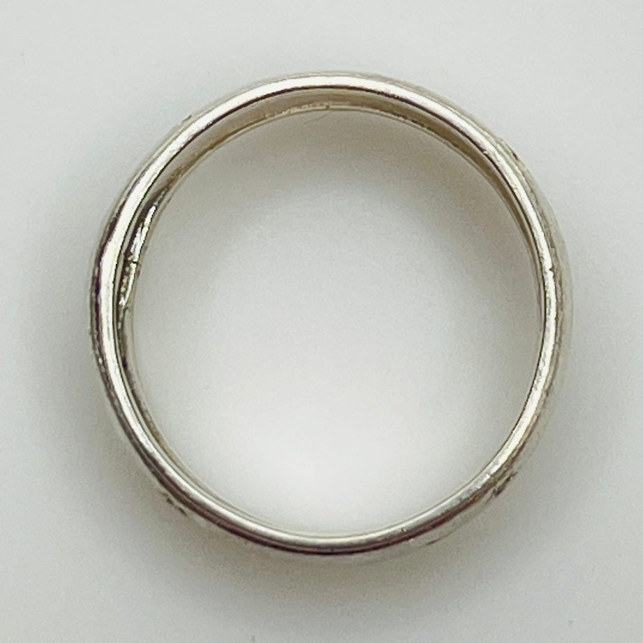 Close-up of engraved sterling ring with star pattern