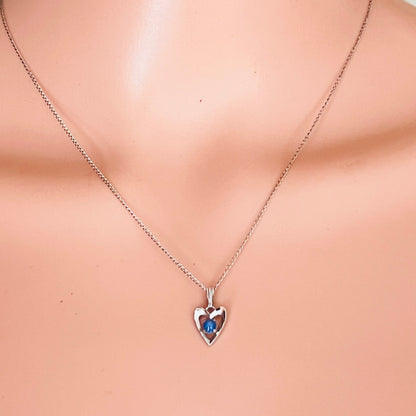 Sterling silver heart pendant with blue star sapphire on mannequin bust