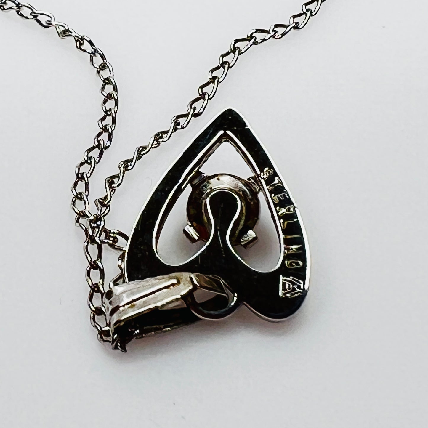 Reverse view showing “STERLING” stamp on back of pendant