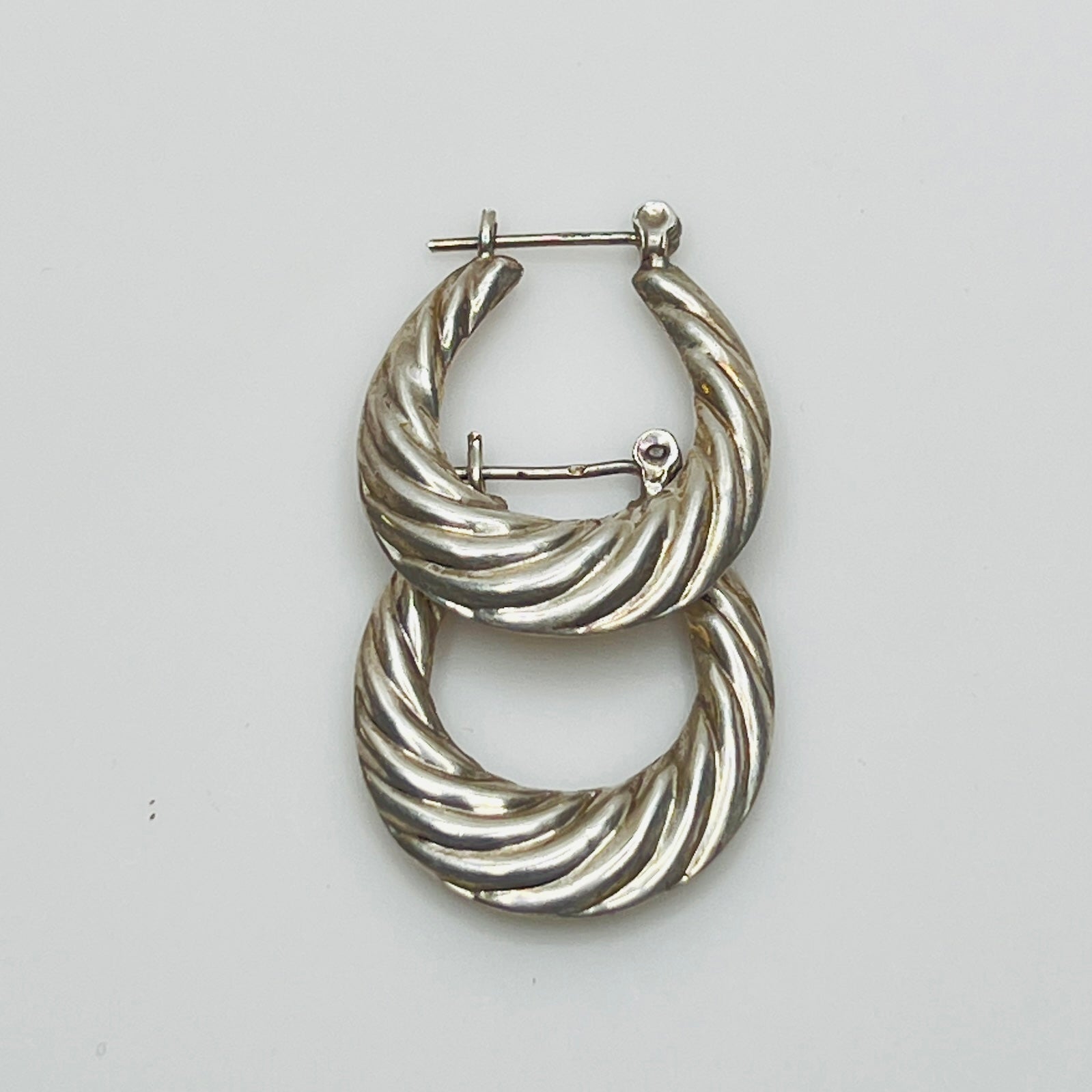Pair of vintage sterling silver hoop earrings with swirl design
