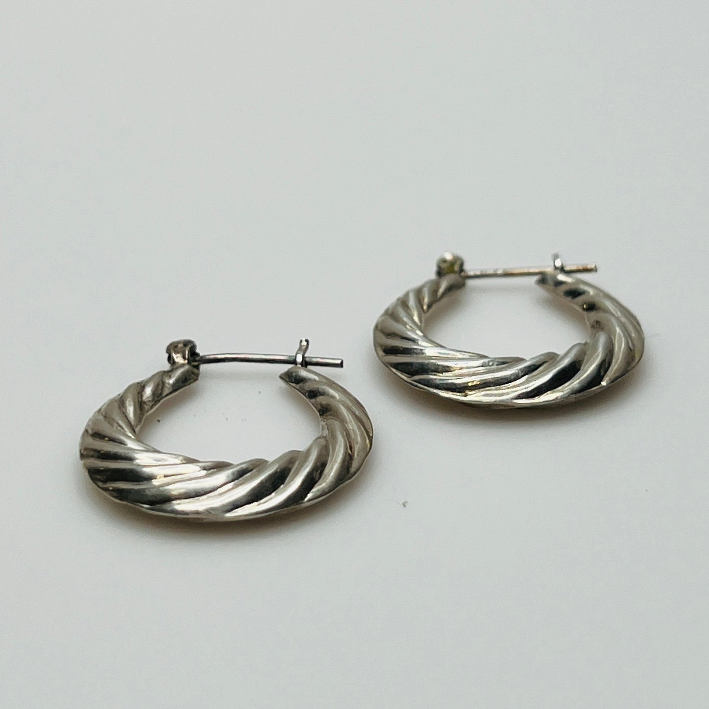 Pair of vintage sterling silver hoop earrings with swirl design