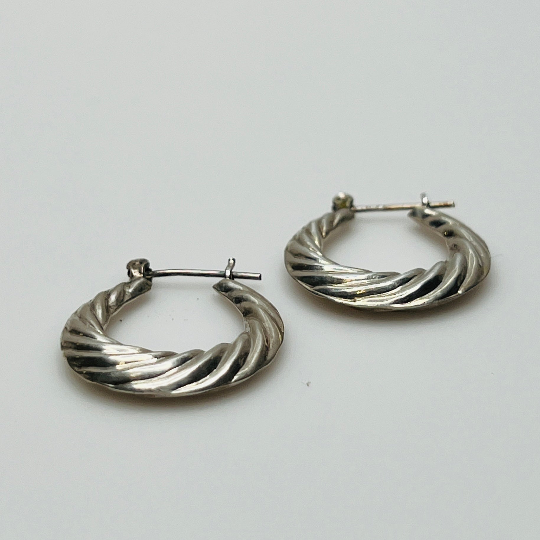 Pair of vintage sterling silver hoop earrings with swirl design