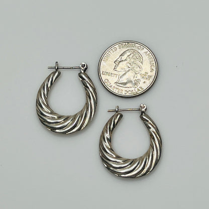 Close-up of silver swirled texture and latch-back closures