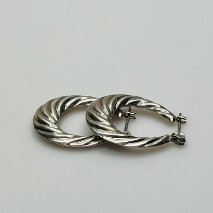 Pair of vintage sterling silver hoop earrings with swirl design