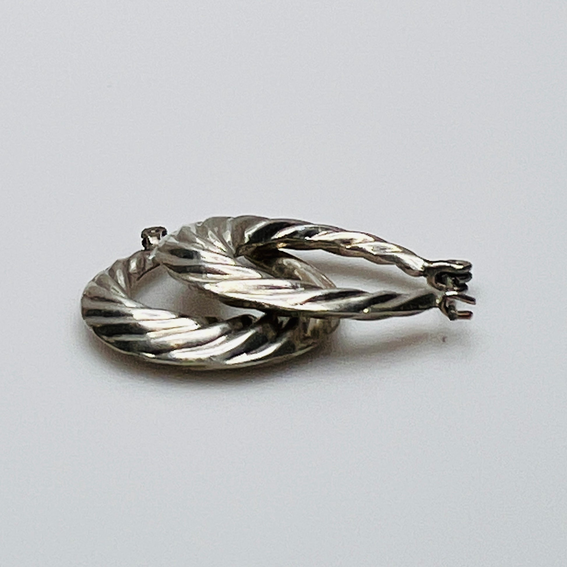 Pair of vintage sterling silver hoop earrings with swirl design