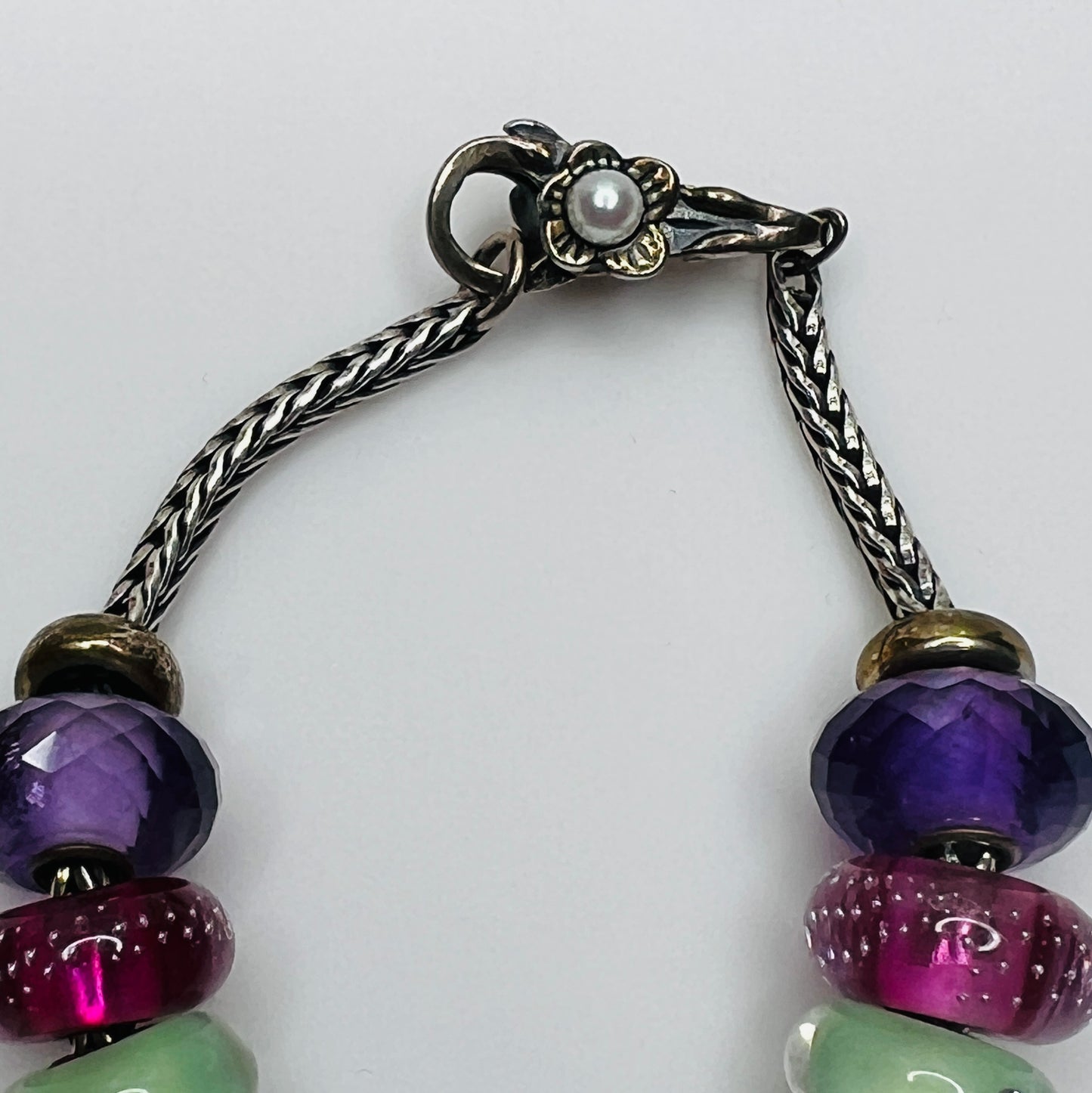 Detail of sterling silver flower clasp with pearl accent on sterling silver chain