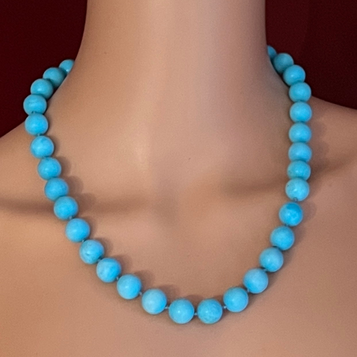 Hand-knotted turquoise bead necklace worn on mannequin, 20 inches long
