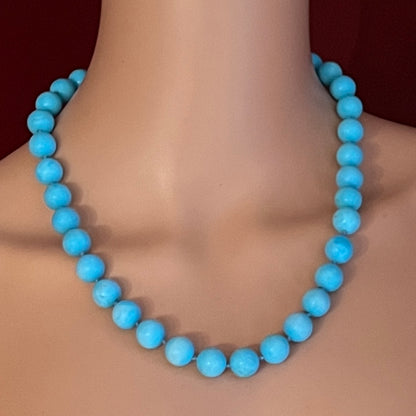 Hand-knotted turquoise bead necklace worn on mannequin, 20 inches long