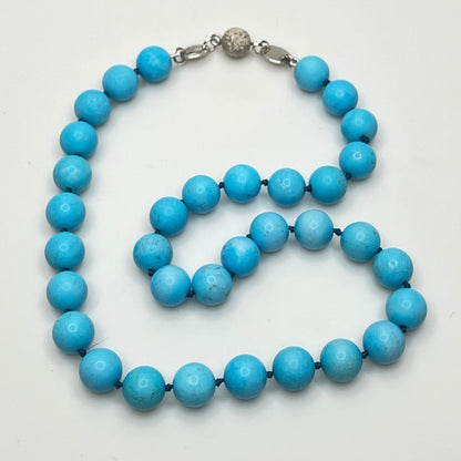 Close-up of turquoise beads with sterling magnetic clasp, laid flat