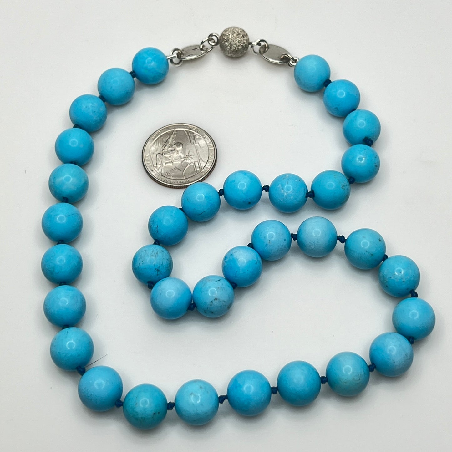 Close-up of turquoise beads with sterling magnetic clasp, laid flat
