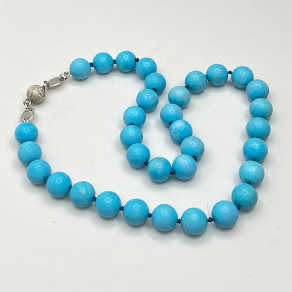Close-up of turquoise beads with sterling magnetic clasp, laid flat