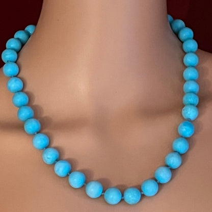 Hand-knotted turquoise bead necklace worn on mannequin, 20 inches long